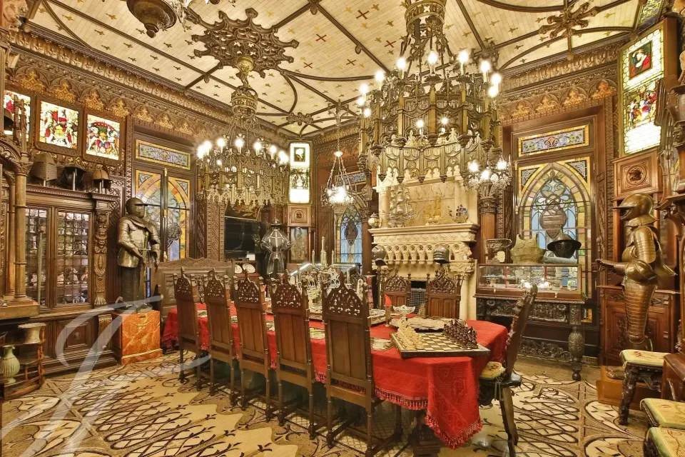 Sala da pranzo del castello con legno intagliato e tavolo apparecchiato
